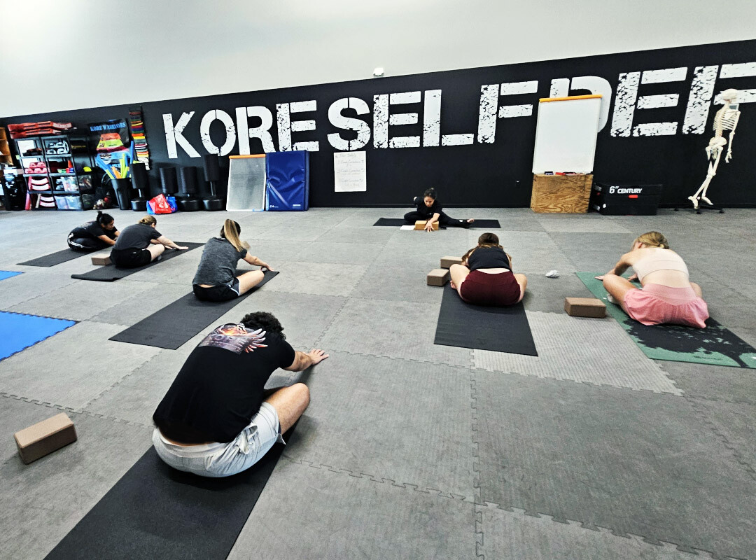 Krav Maga Practitioners Engage in Stretches Krav Maga Practitioners Engage in Stretches